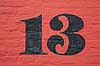 Tretten. Husnummeret 13 p� r�dmalet mur i Maribo  Maribo Danmark   k�bst�der, Lolland, uheld