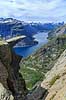 Trolltunga. Fjeldvandrer p� Trolltunga, en klippeformation der stikker ud af klippesiden 700 meter over Ringedalvatnet n�r Hardangervidda National Park  Trolltunga / Tyssedal Norge   Vandring, vandretur, fjeldvandring, turisme, hiking